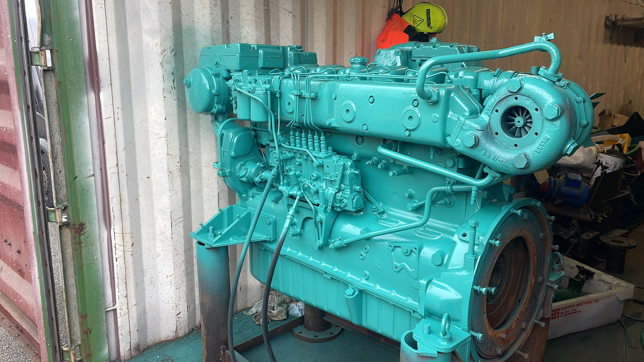 A large marine engine is being repaired.
